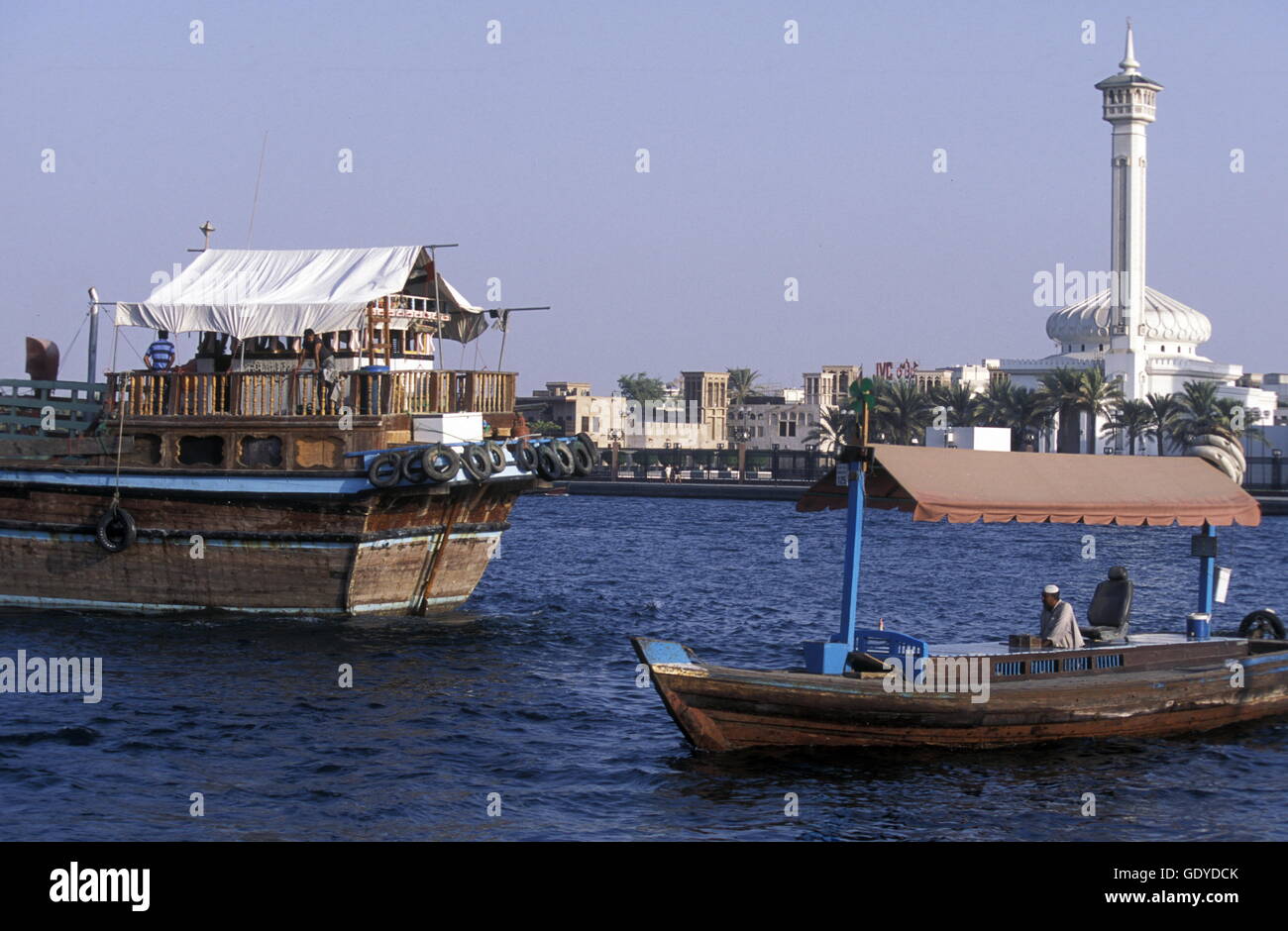 a city boat and ferry on the Dubai creek in the old town in the city of ...