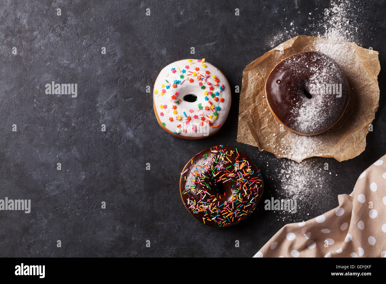 Colorful donuts on stone table. Top view with copy space Stock Photo ...
