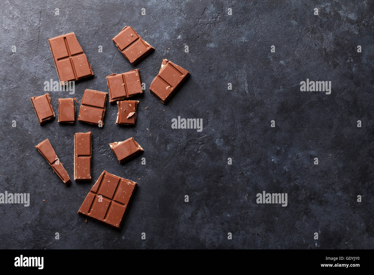 Chocolate on dark stone background. Top view with copy space Stock Photo