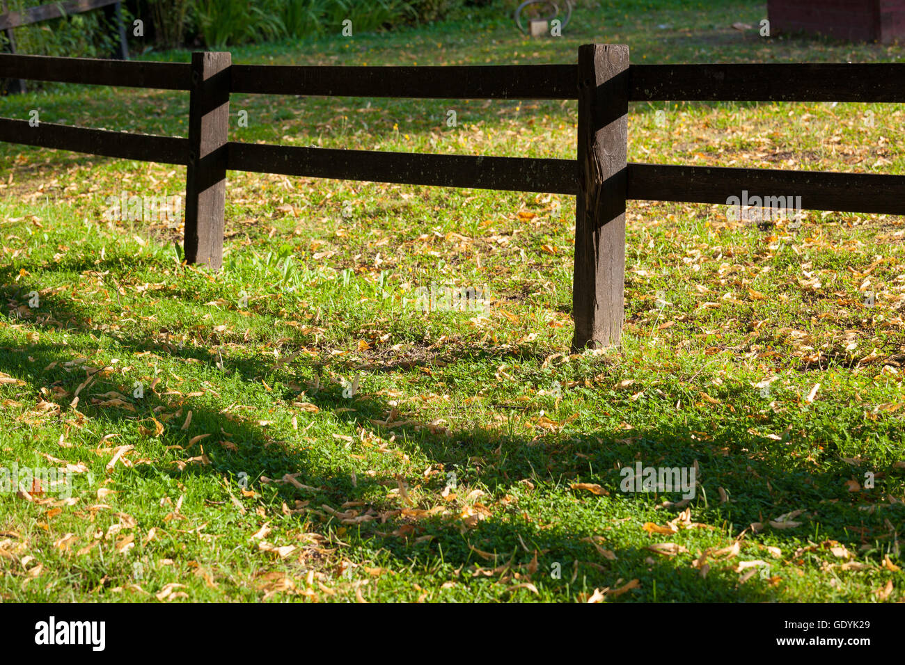 Wooden fence near playground and sunny weather Stock Photo - Alamy