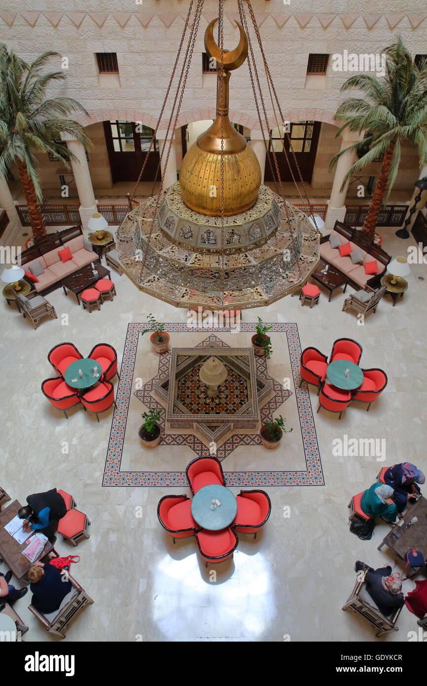 The magnificent courtyard atrium of the Movenpick Hotel in Petra, Jordan, located at the entrance of the site Stock Photo