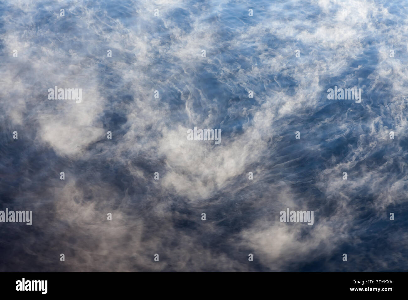 Water vapor on surface of cold icy water at sunny cold winter day Stock Photo