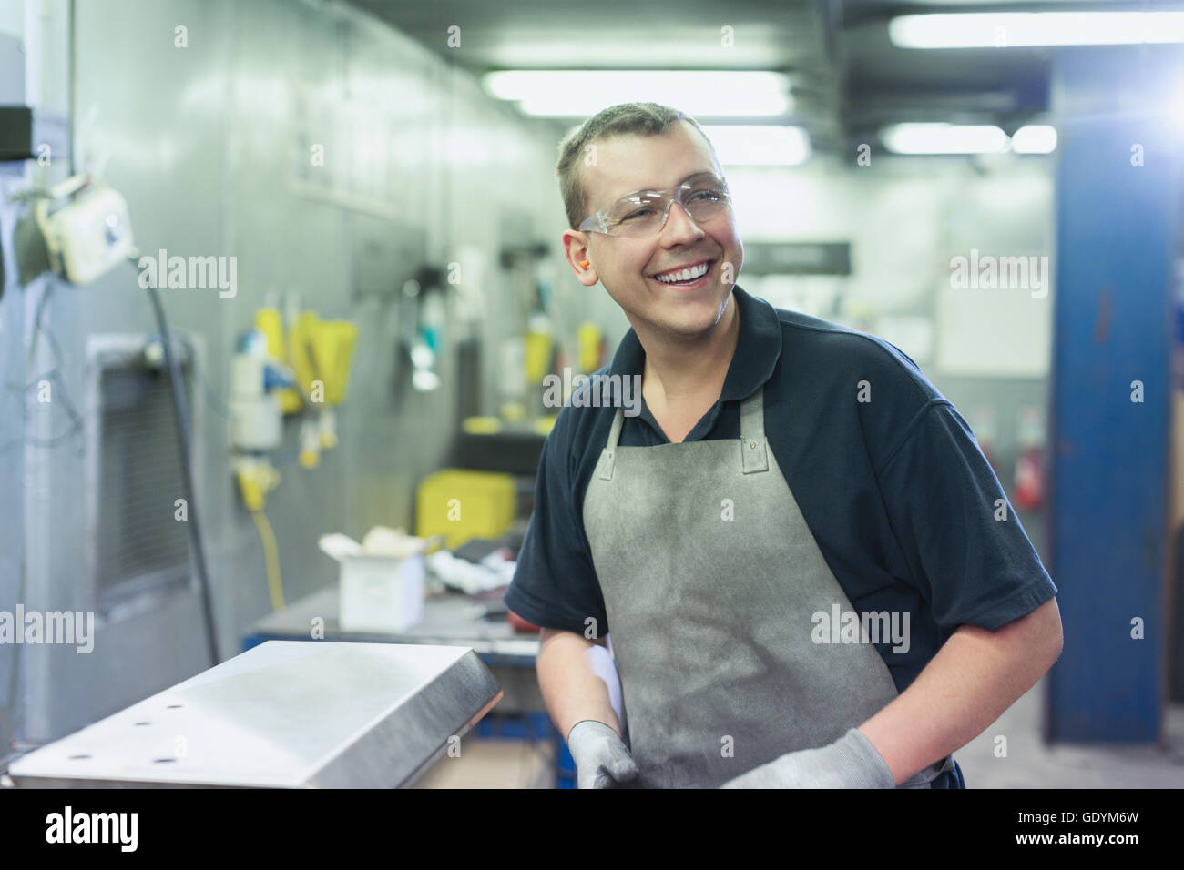 Smiling worker in steel factory Stock Photo - Alamy