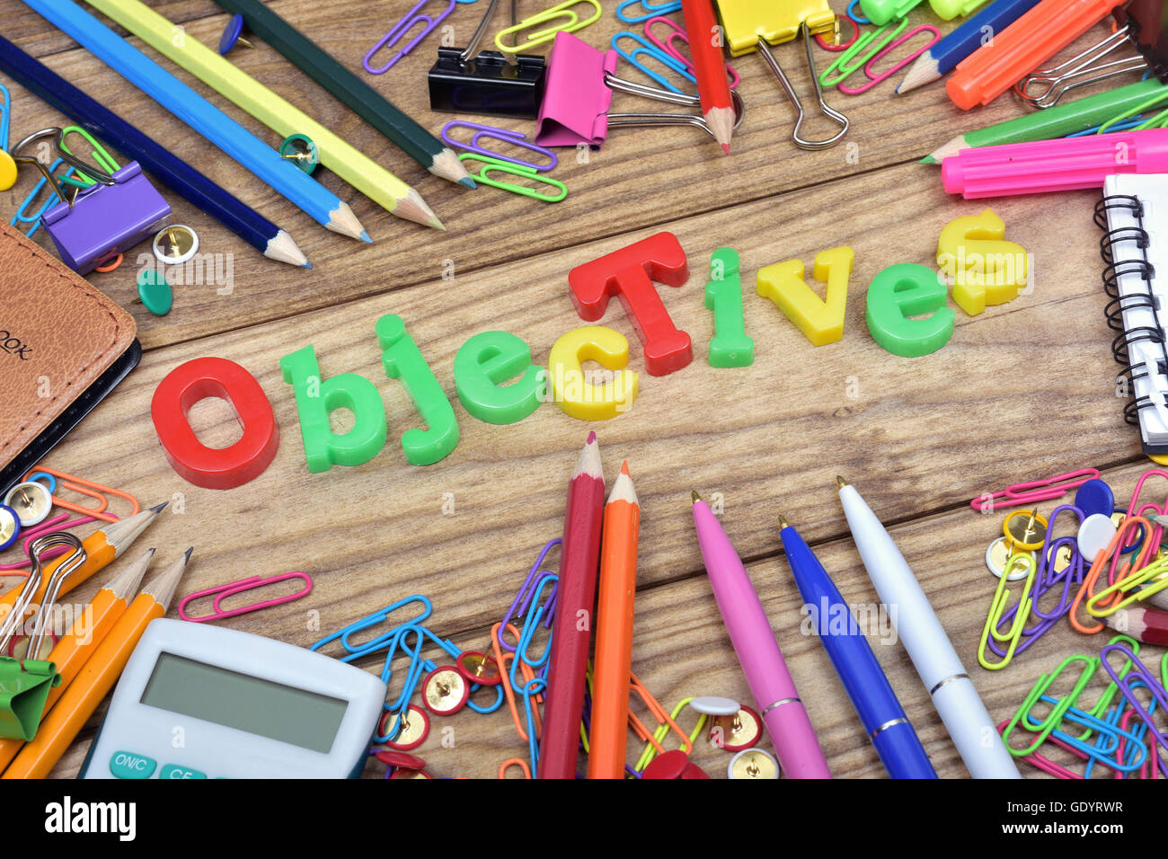 Objectives word and office tools on wooden table Stock Photo - Alamy
