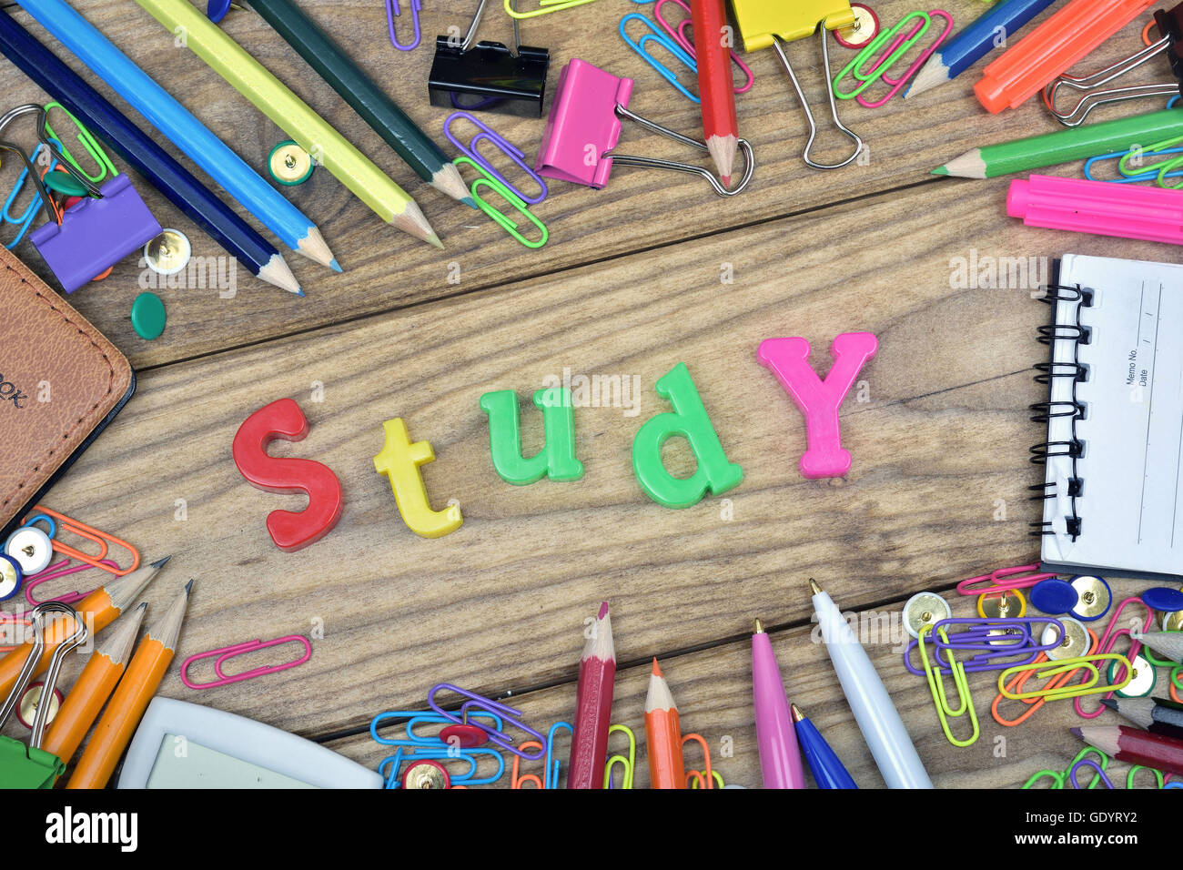Study word and office tools on wooden table Stock Photo - Alamy