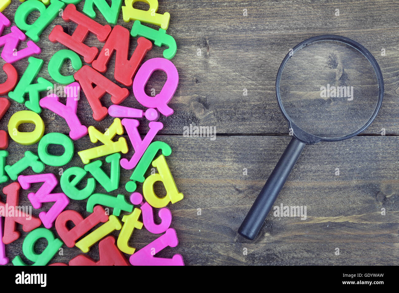 Magnifying glass word on wooden table Stock Photo Alamy