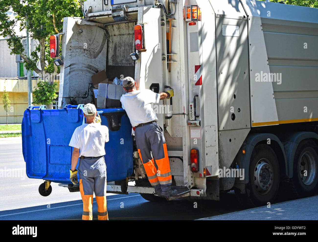 Garbage truck works in the city street Stock Photo Alamy