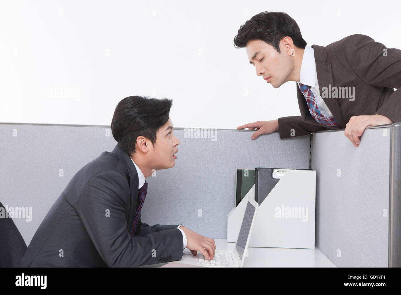 Side view portrait of two nervous business men face ro faceat work Stock Photo