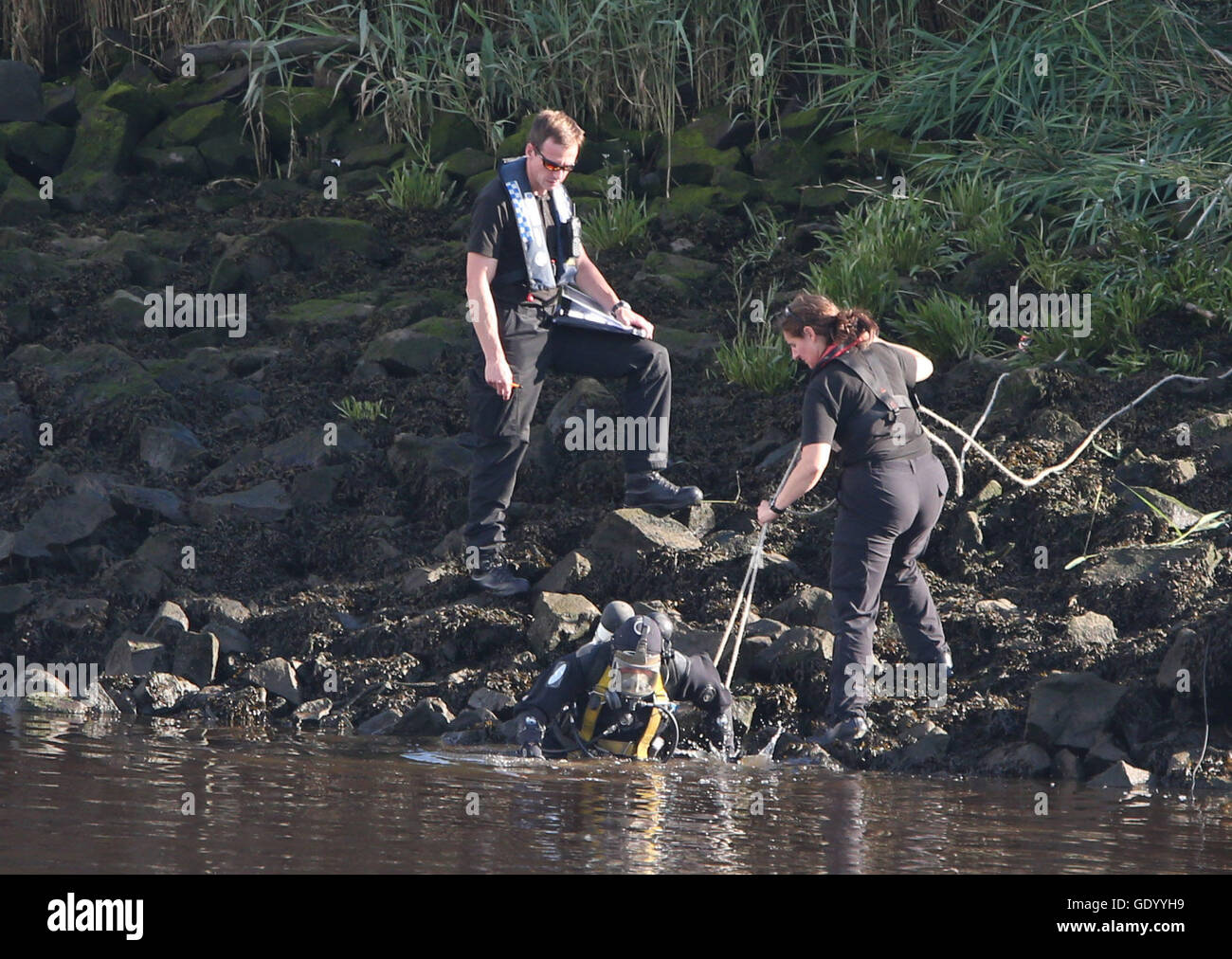 A police diver enters the River Clyde in Renfrew to aid recovery of the ...