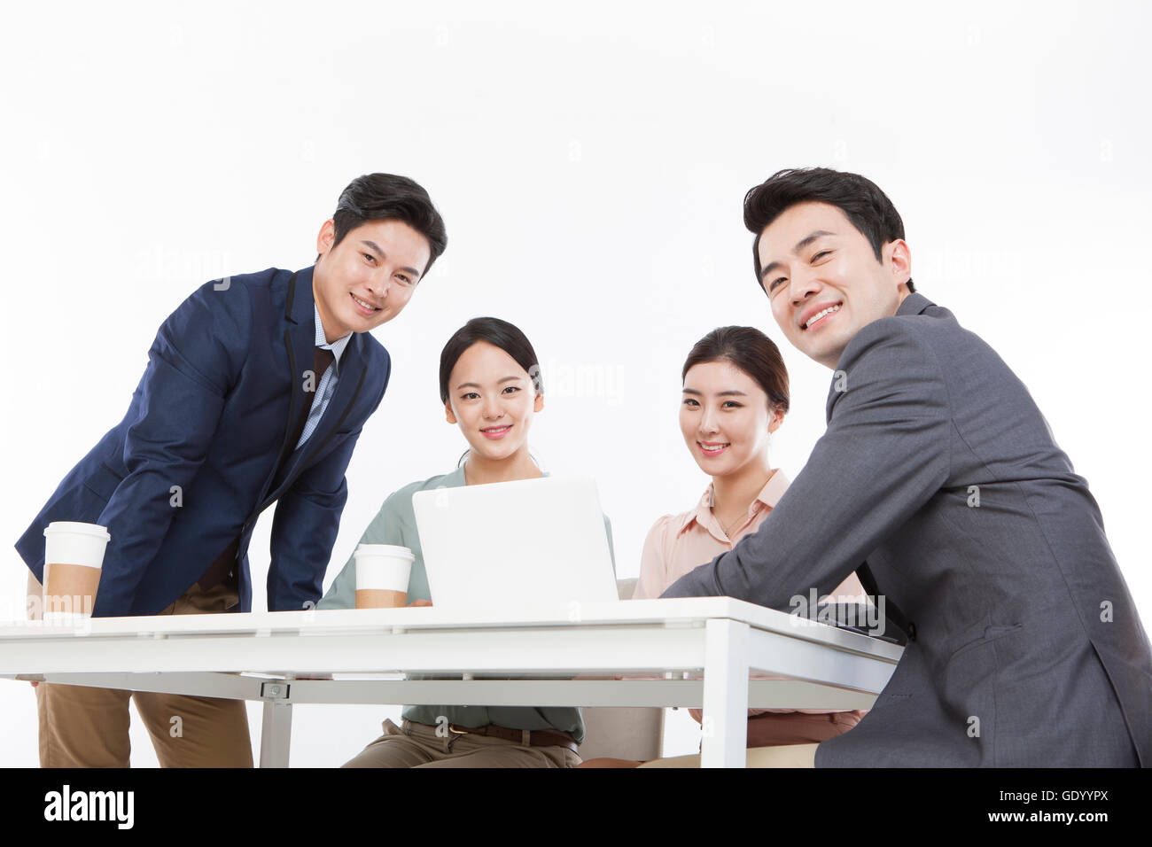 Business people with a notebook computer smiling at front Stock Photo