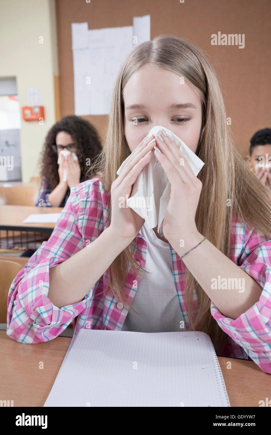university student blowing nose with handkerchief, Bavaria, Germany Stock Photo