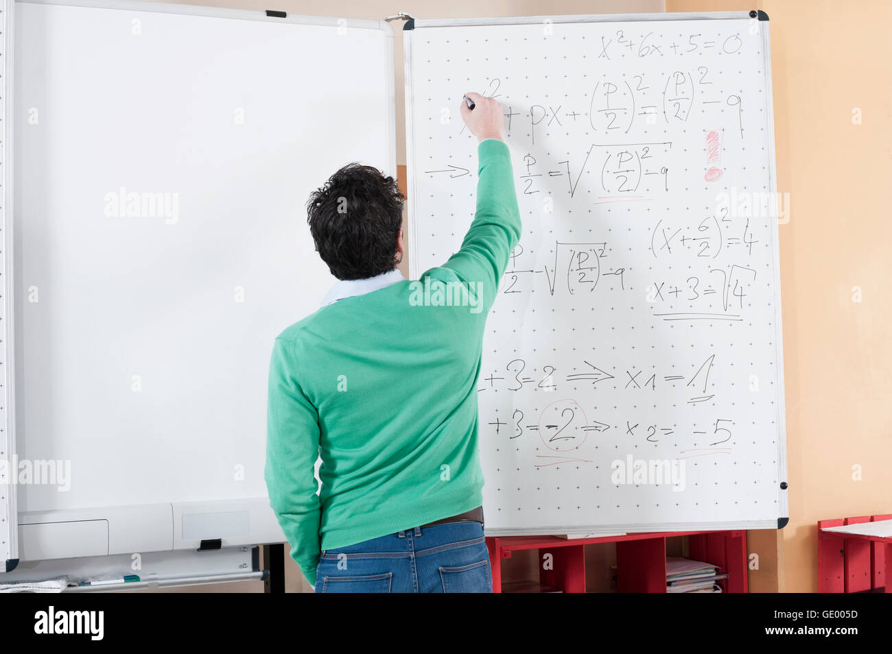 Teacher teaching mathematics on whiteboard, Bavaria, Germany Stock Photo
