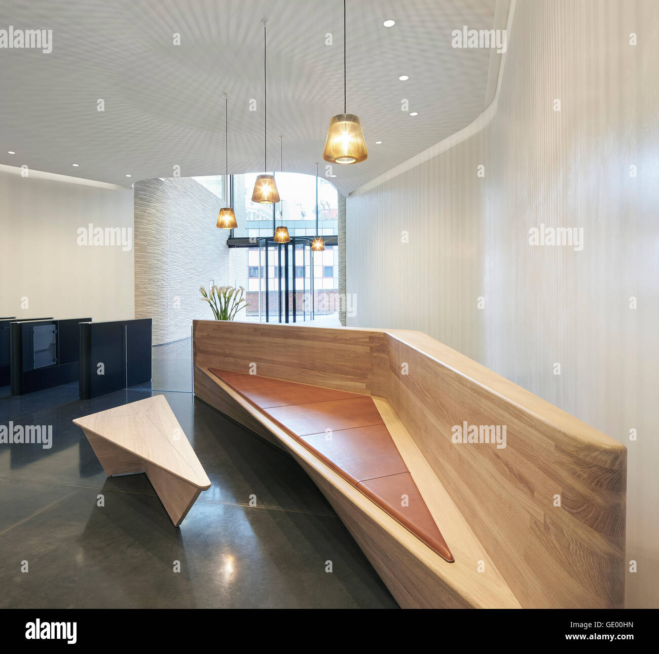 Wooden reception desk with integrated bench. Turnmill Building, London