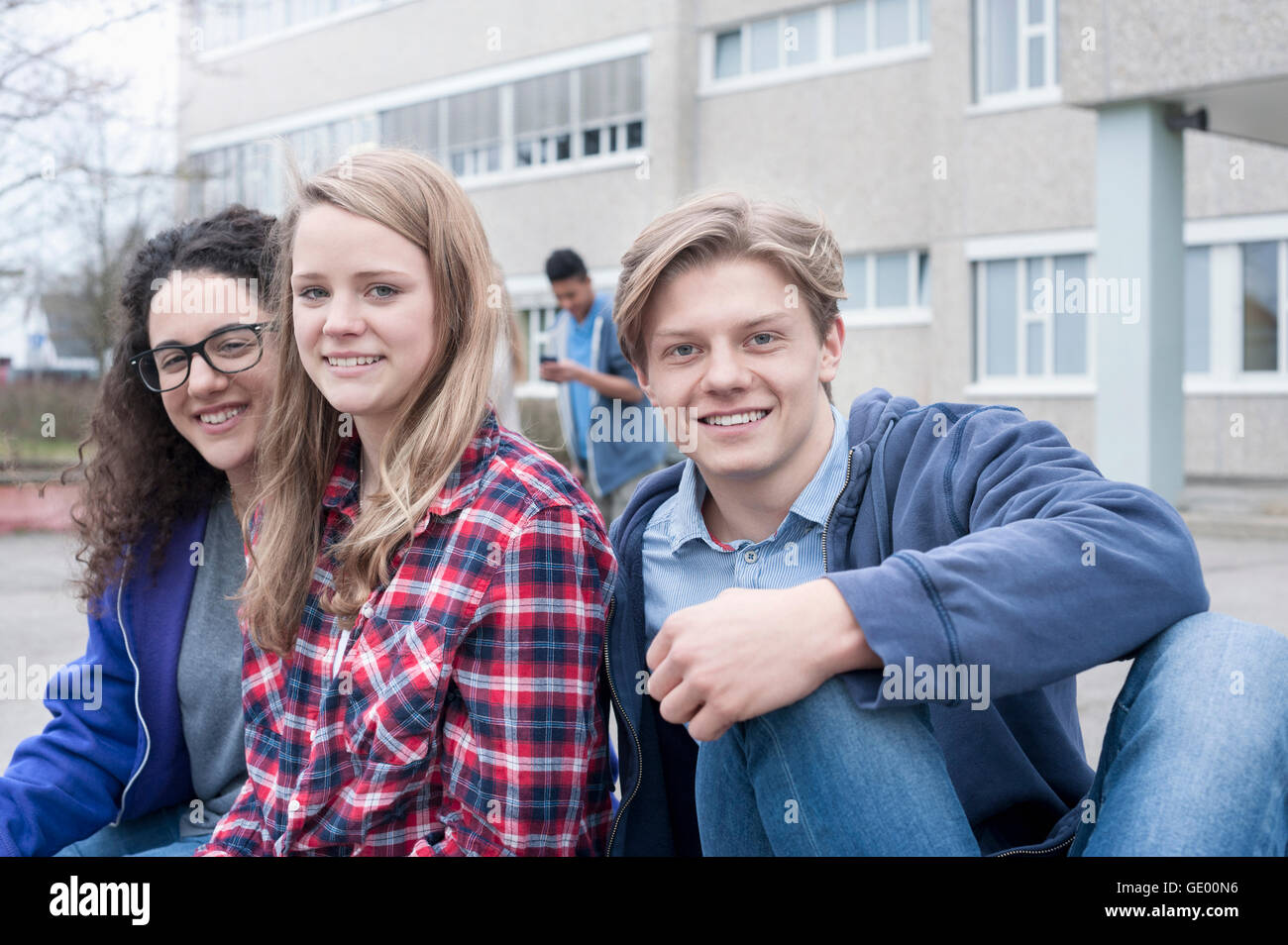 university students sitting in campus and smiling, Bavaria, Germany Stock Photo