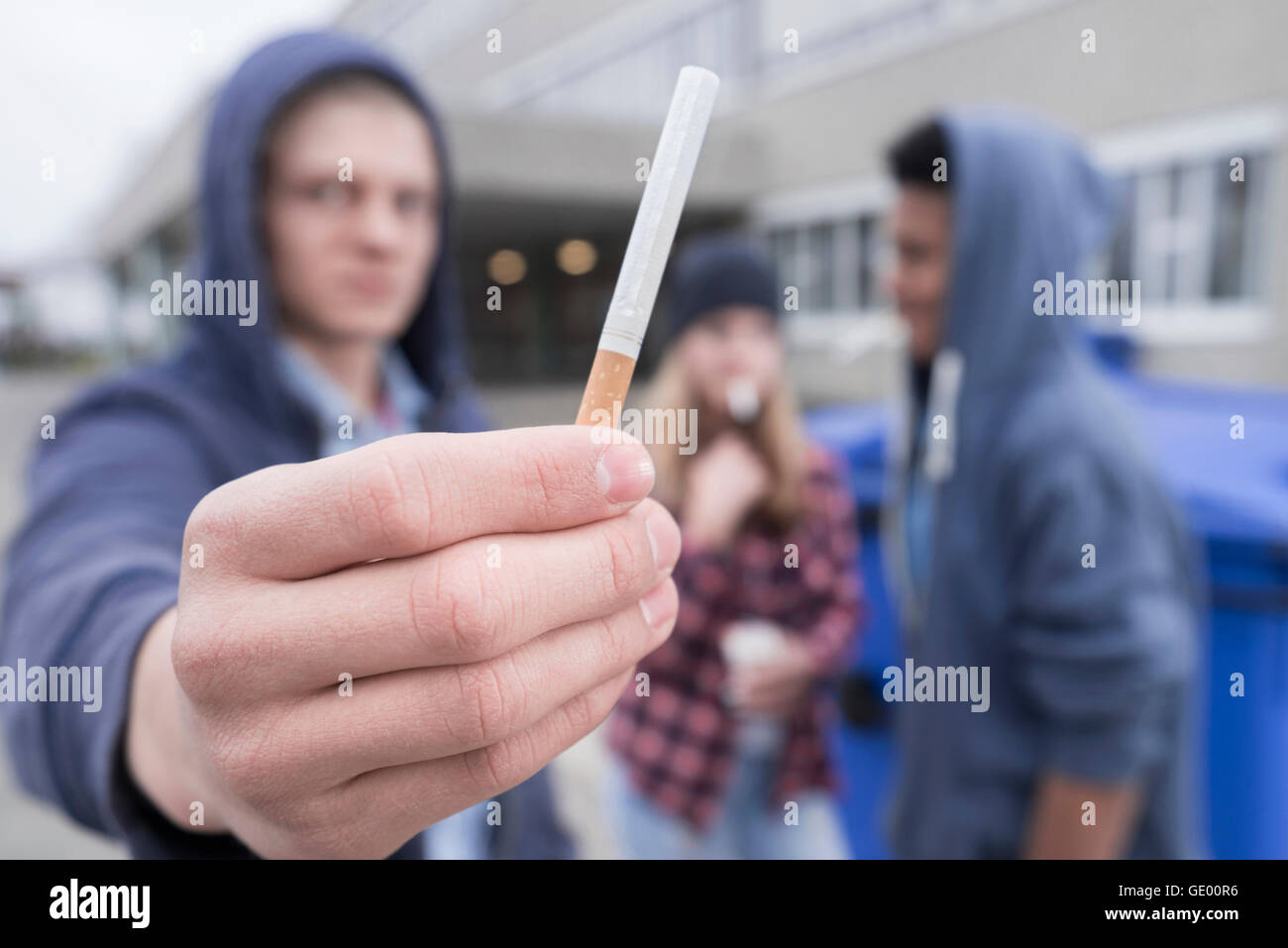 university student showing cigarette in campus, Bavaria, Germany Stock Photo