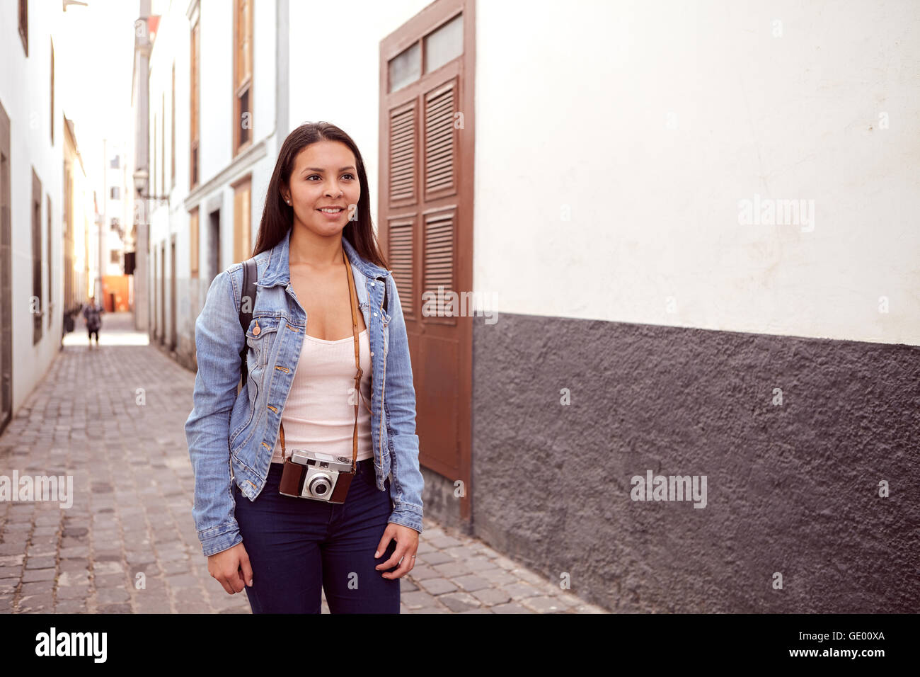 Beautiful woman wearing jeans standing in the street Stock Photo - Alamy