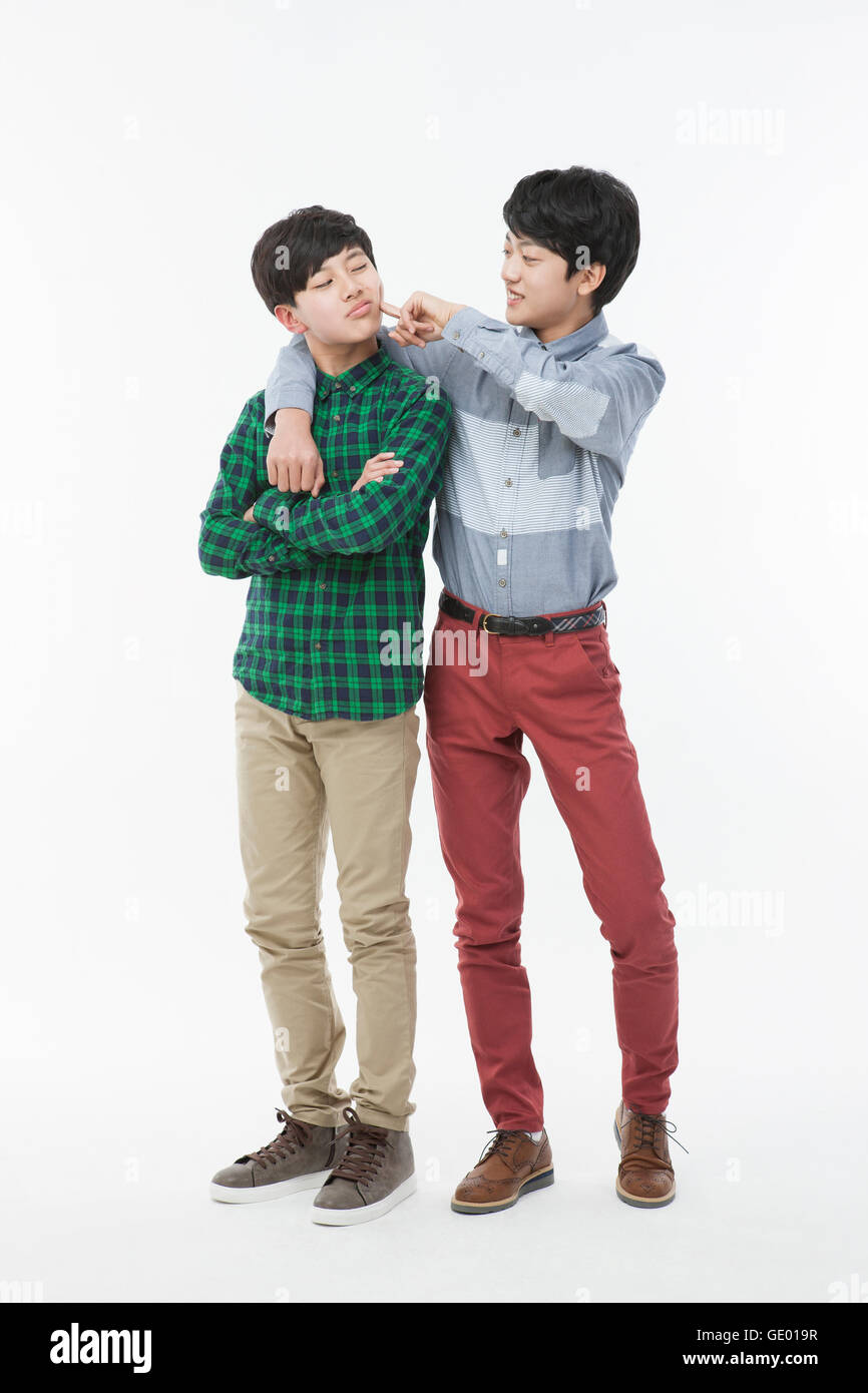 Two smiling school boys in casual clothes standing Stock Photo