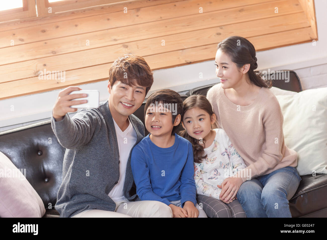 Harmonious family posing to take a selfie Stock Photo
