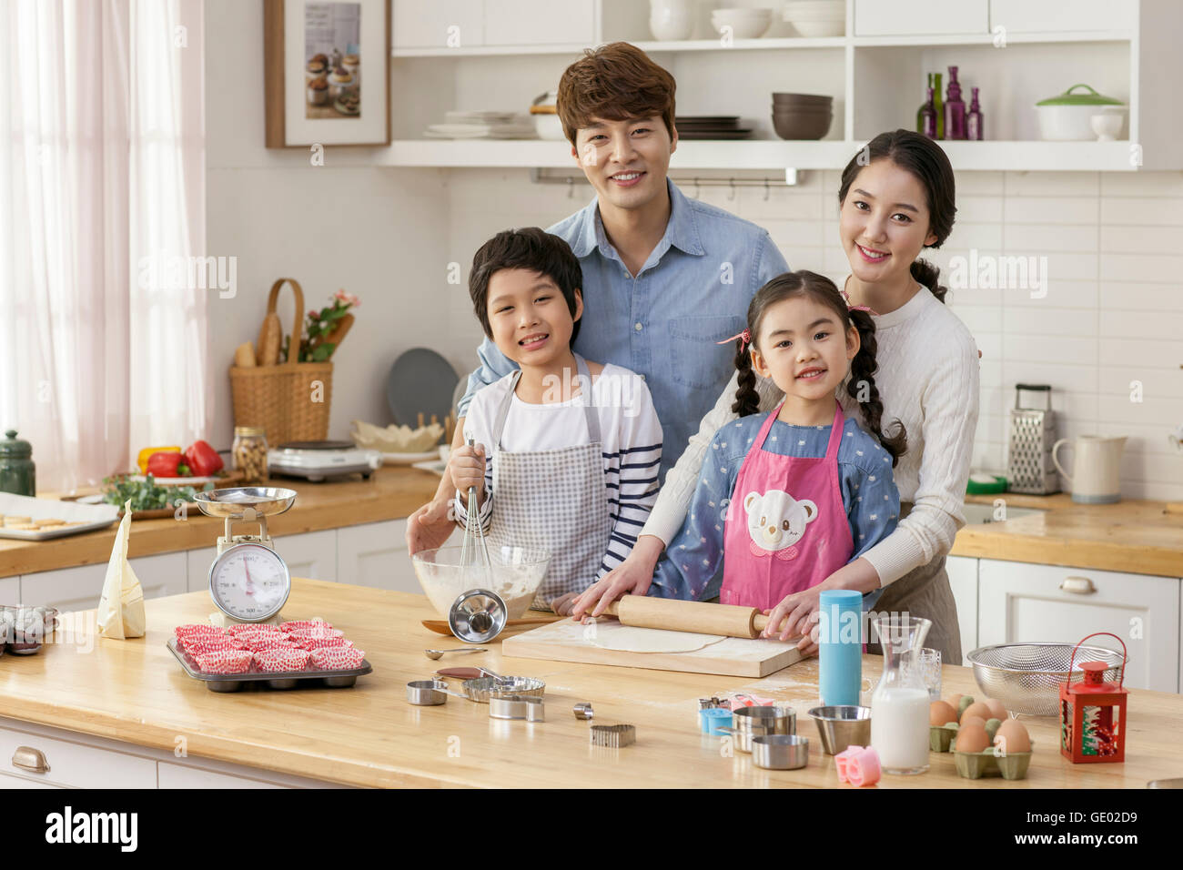 Harmonious family cooking together in kitchen Stock Photo