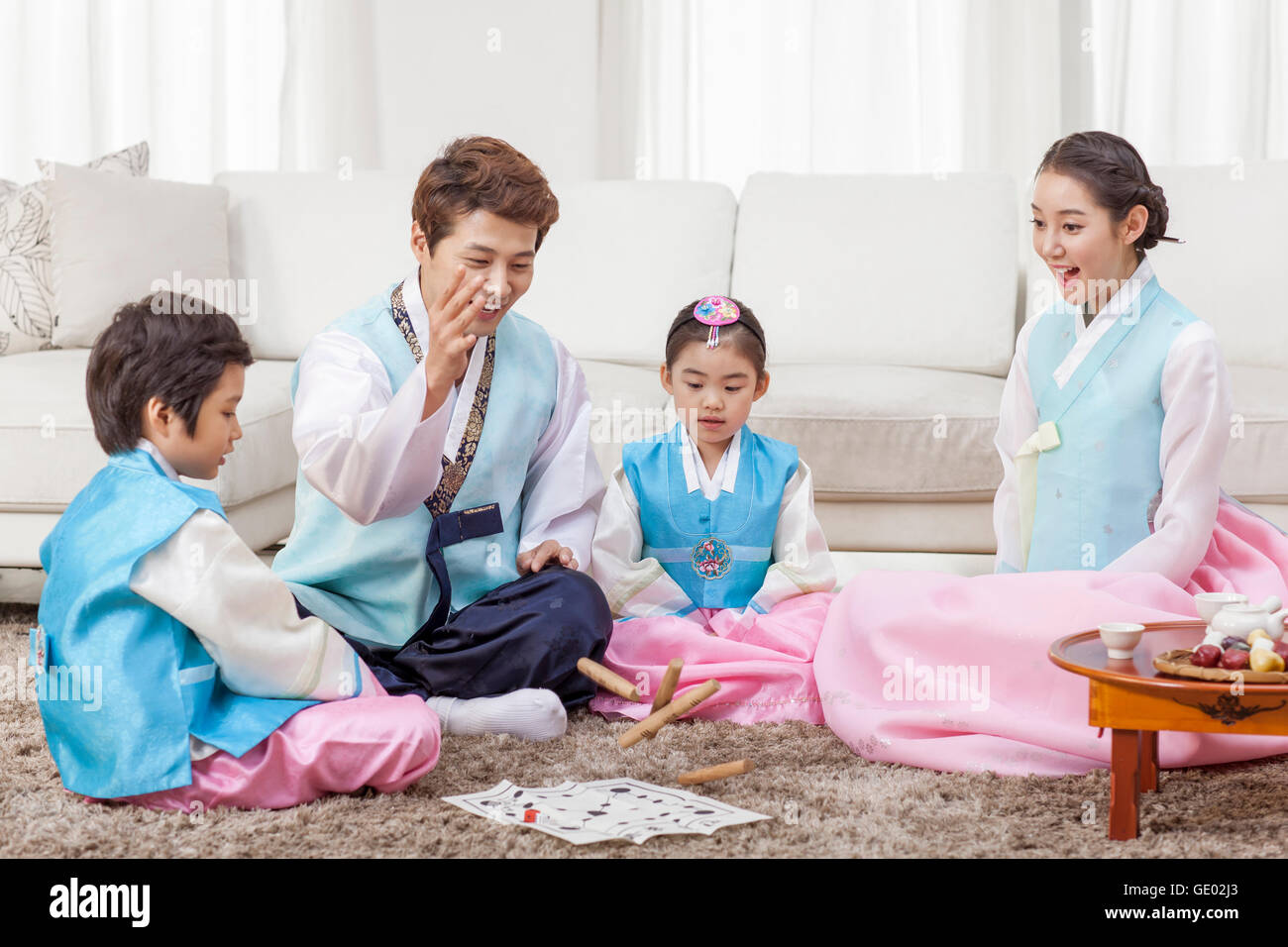 Harmonious Korean family playing yut, traditional Korean game Stock Photo Alamy
