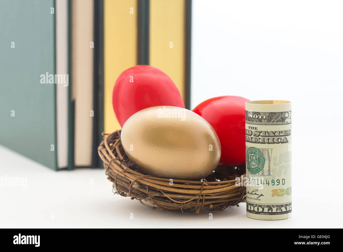 American dollar next to red and gold nest eggs reflect high costs of education. Stock Photo