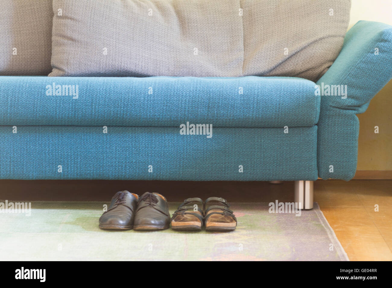 Sofa in living room with shoes Stock Photo