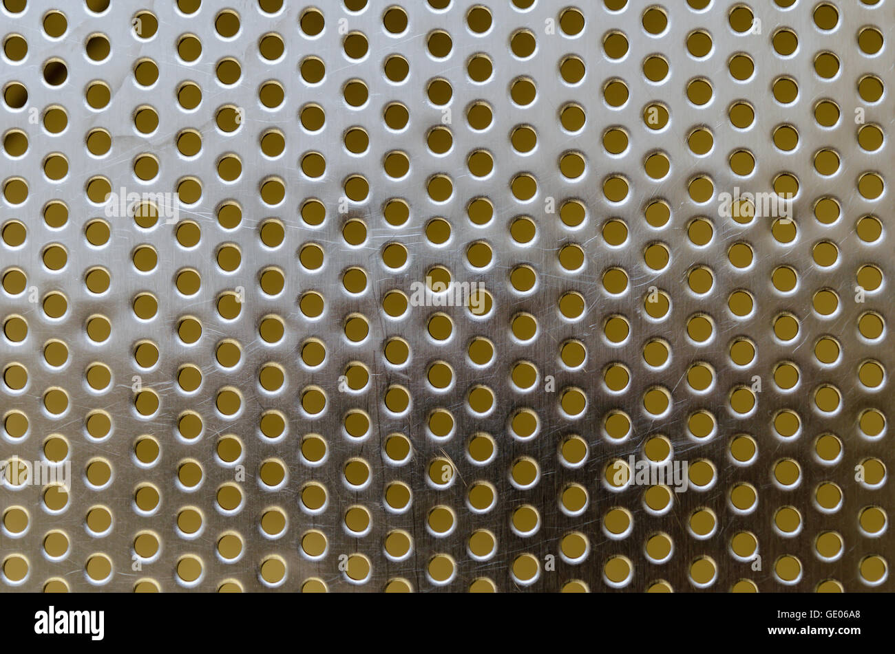 Metal stainless steel shiny flat grille with round holes and scratches