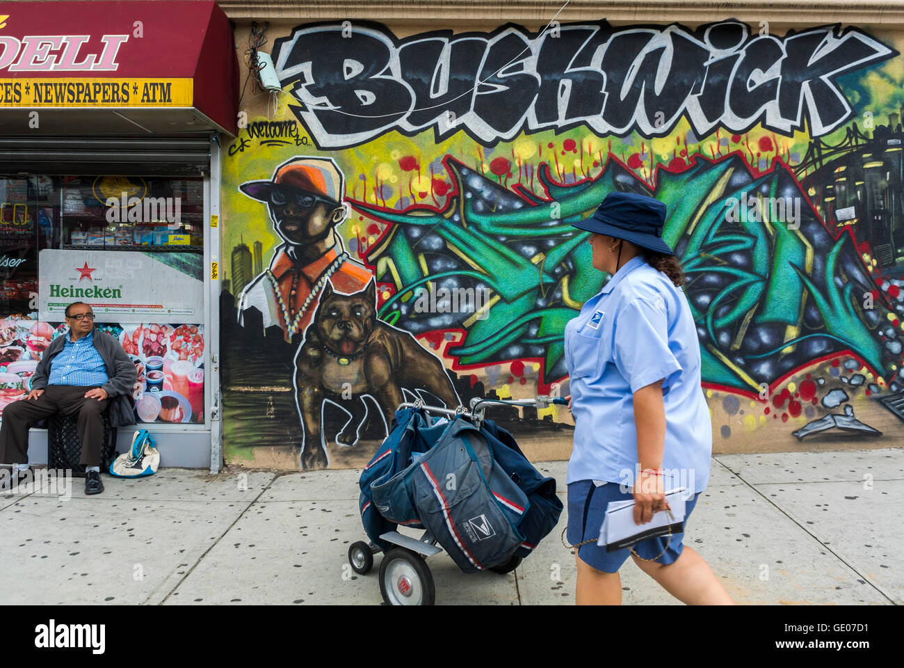 New York City, NY, USA, American People in Brooklyn, Bushwick Neighborhood, Female Mailperson, Walking Store Front Street Art, Gentrification of city areas in US Stock Photo