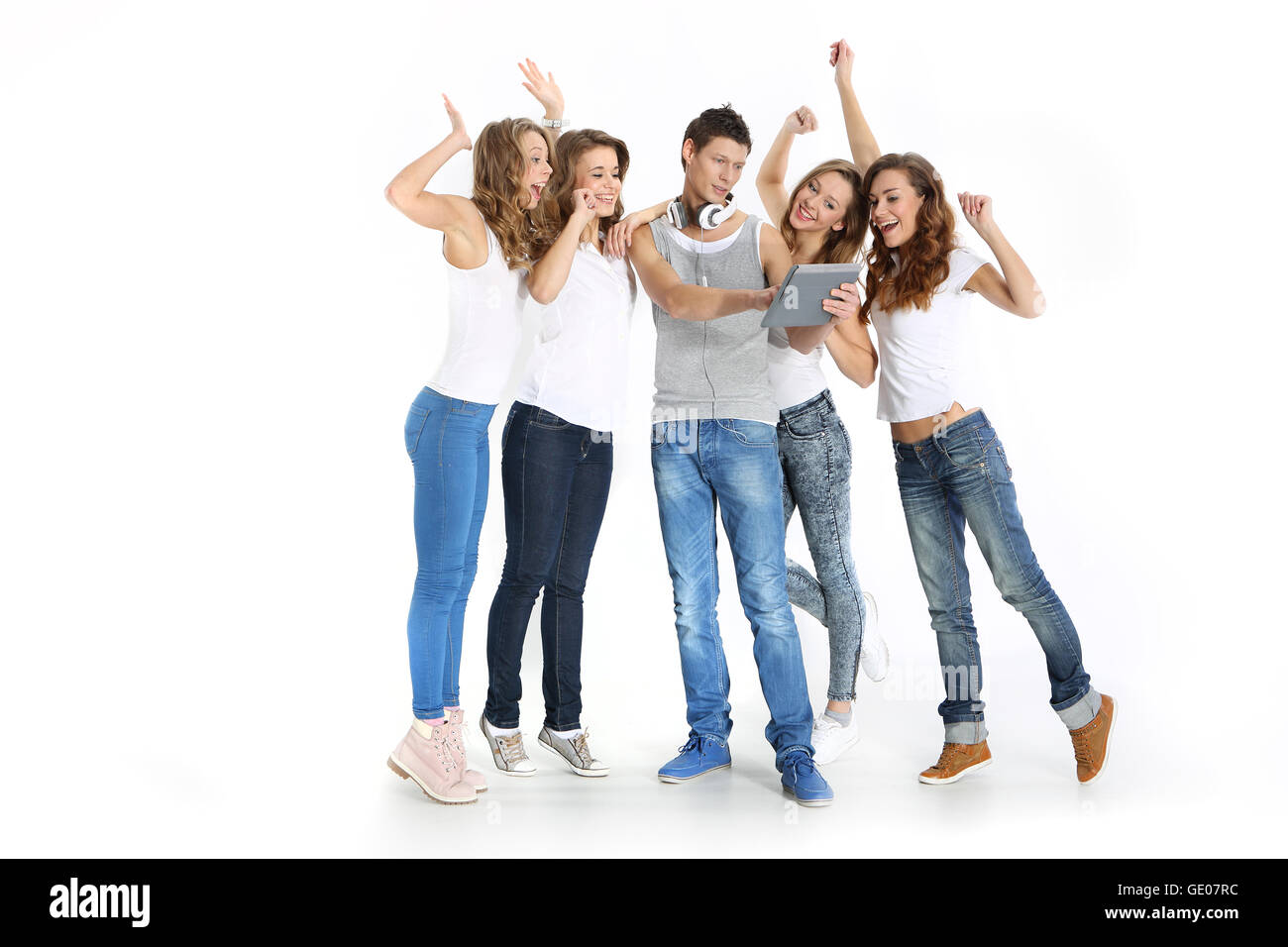 Group of young people watching the results on a digital tablet. Stock Photo