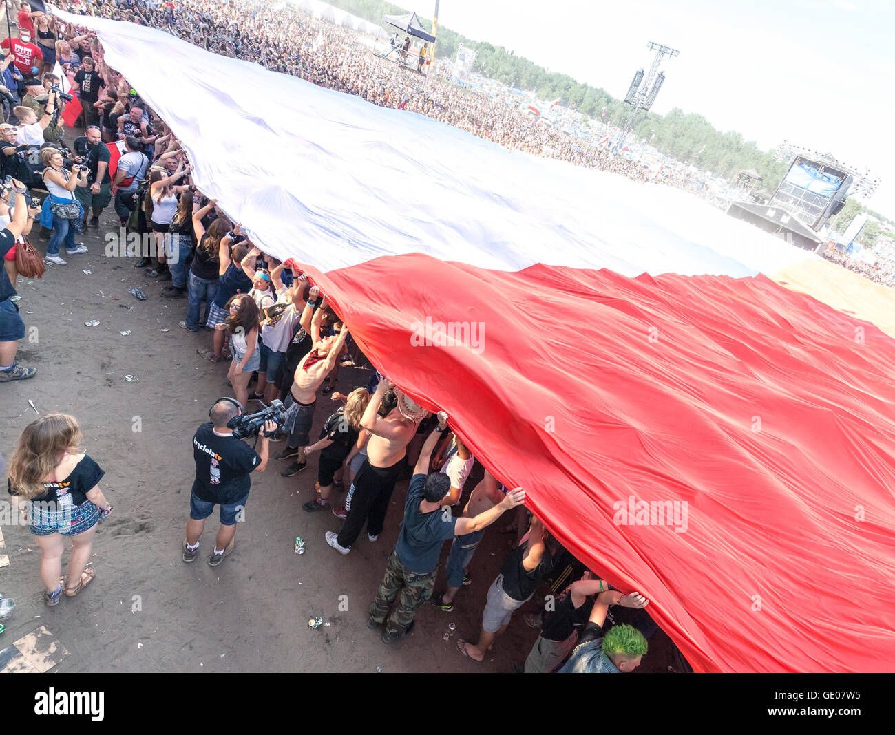 Polish flag spread by audience to commemorate the 71st anniversary of the Warsaw Uprising during 21th Woodstock Festival Poland. Stock Photo