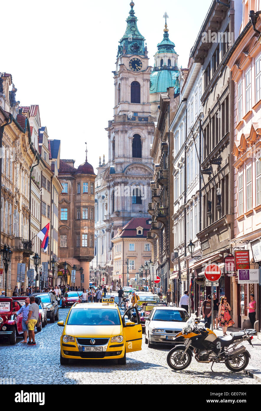 PRAGUE, CZECH REPUBLIC - JUNE 12, 2014:  Street of Prague crowded with tourists and vehicles. Stock Photo