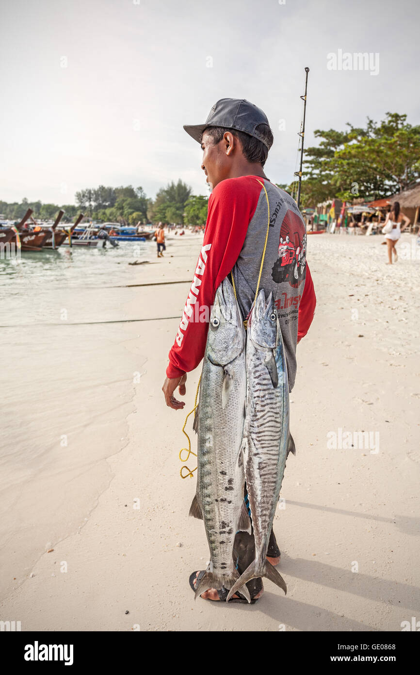 Koh Lipe, Thailand - January 11, 2015: Local fisherman with two big fishes on the beach. Stock Photo