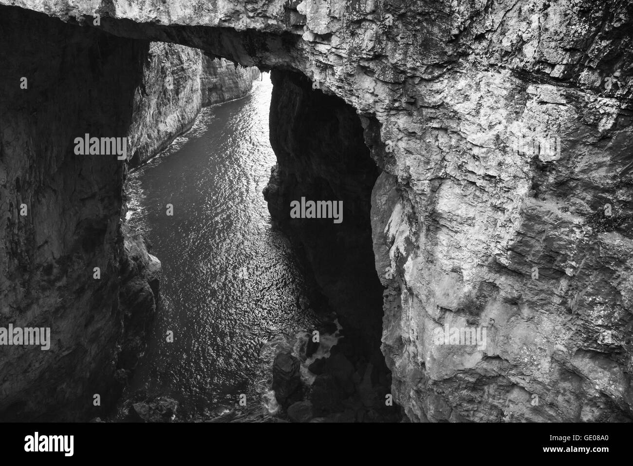 Black and white photo of Grotta del Turco. It is a popular grotto which ends directly in the sea. Gaeta, Italy Stock Photo