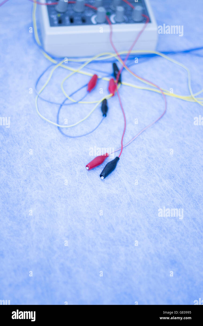 Dry needling electroacupunture cables connecting machine to needles used by acupunturist on