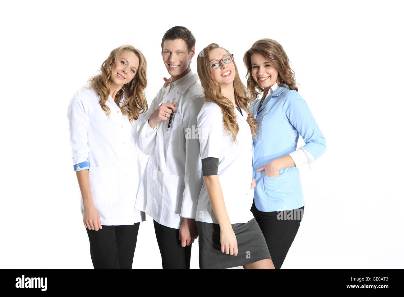 Four young attractive doctors in white, blue aprons on a white