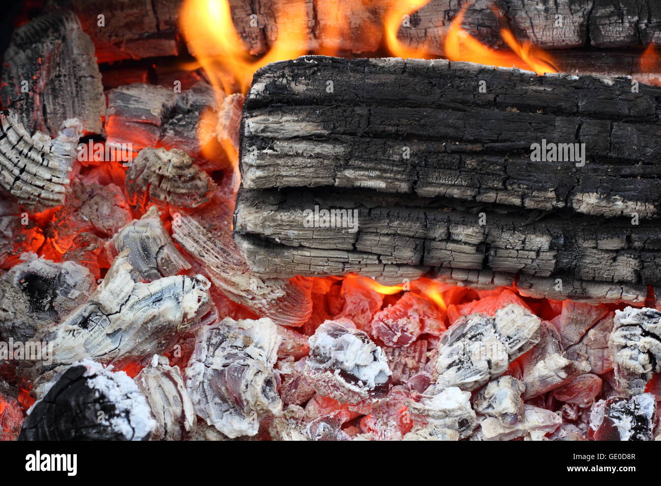 Flame on hot live charcoal extreme closeup photo Stock Photo