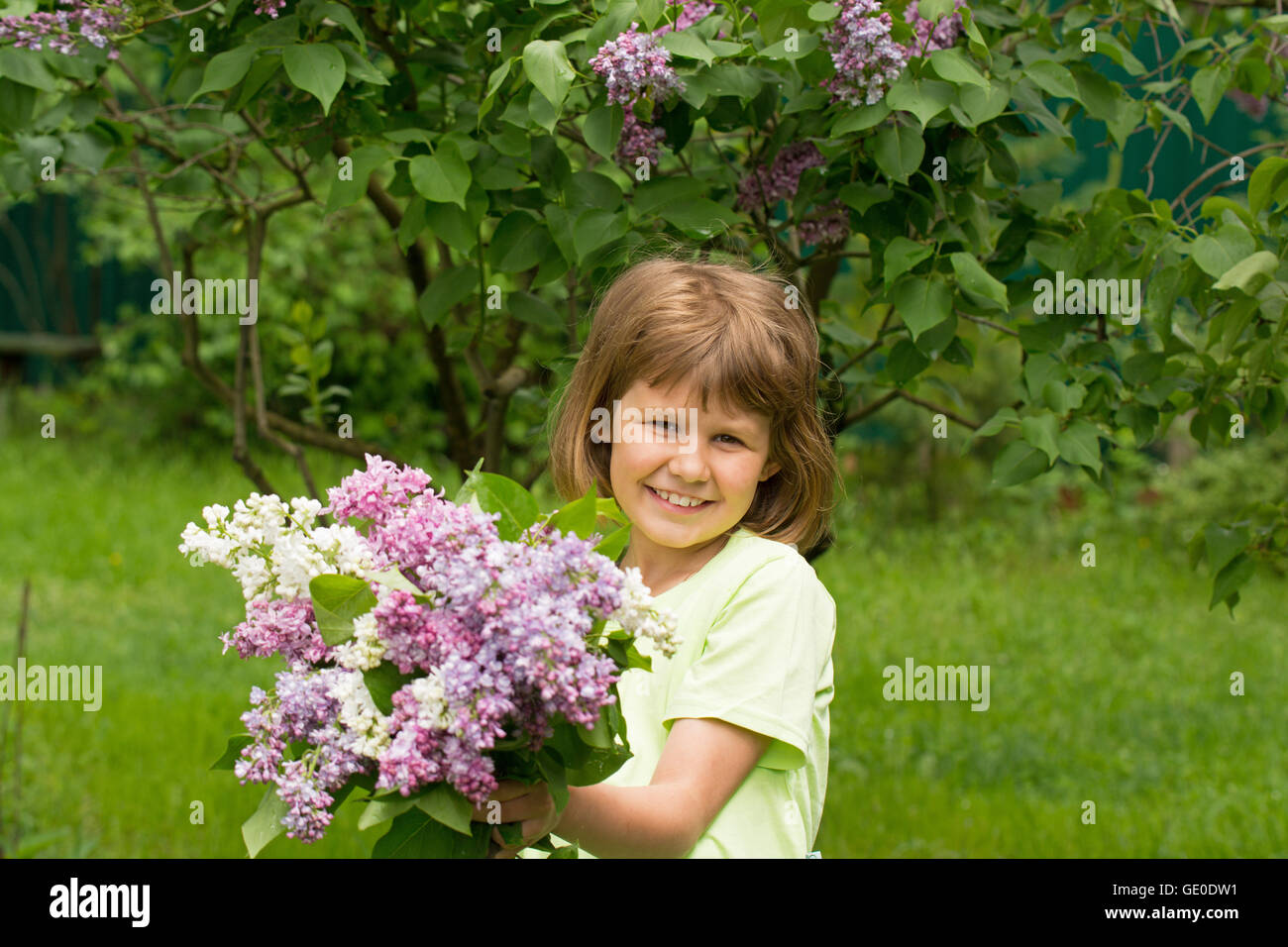 Girl with a bouquet of lilacs Stock Photo - Alamy