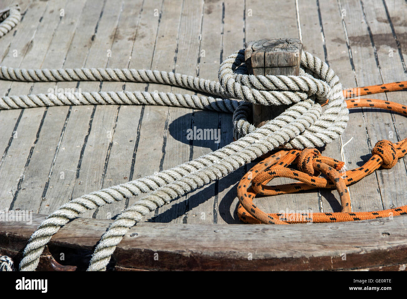 Budva harbor, Montenegro - Mooring ropes on a deck of the traditional wooden fishing boat of the Adriatic Sea Stock Photo