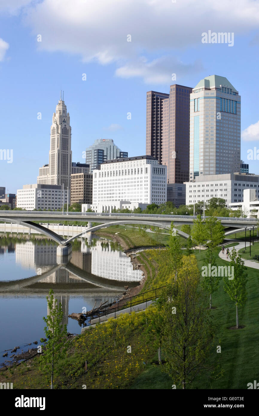 Portrait Cityscape of Columbus City in Ohio USA showing sky scrapers on the bank of the River Scioto and reflections of a bridge Stock Photo