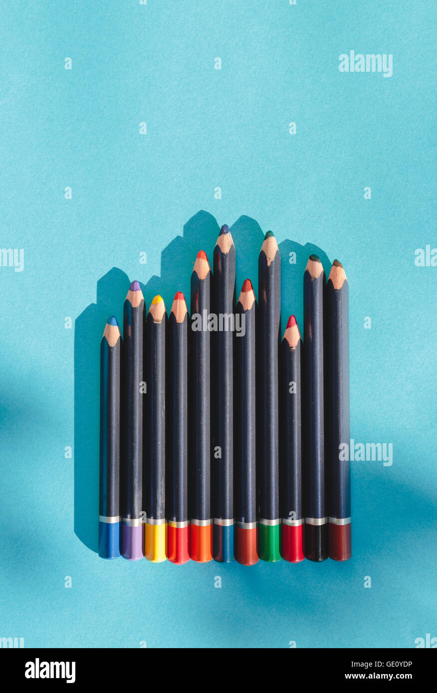 Crayons on blue background Stock Photo