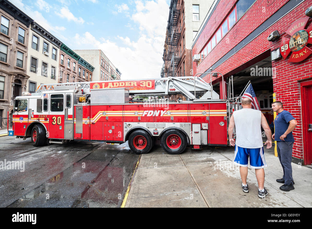 FDNY fire truck backs into garage in New York City Harlem district. Stock Photo