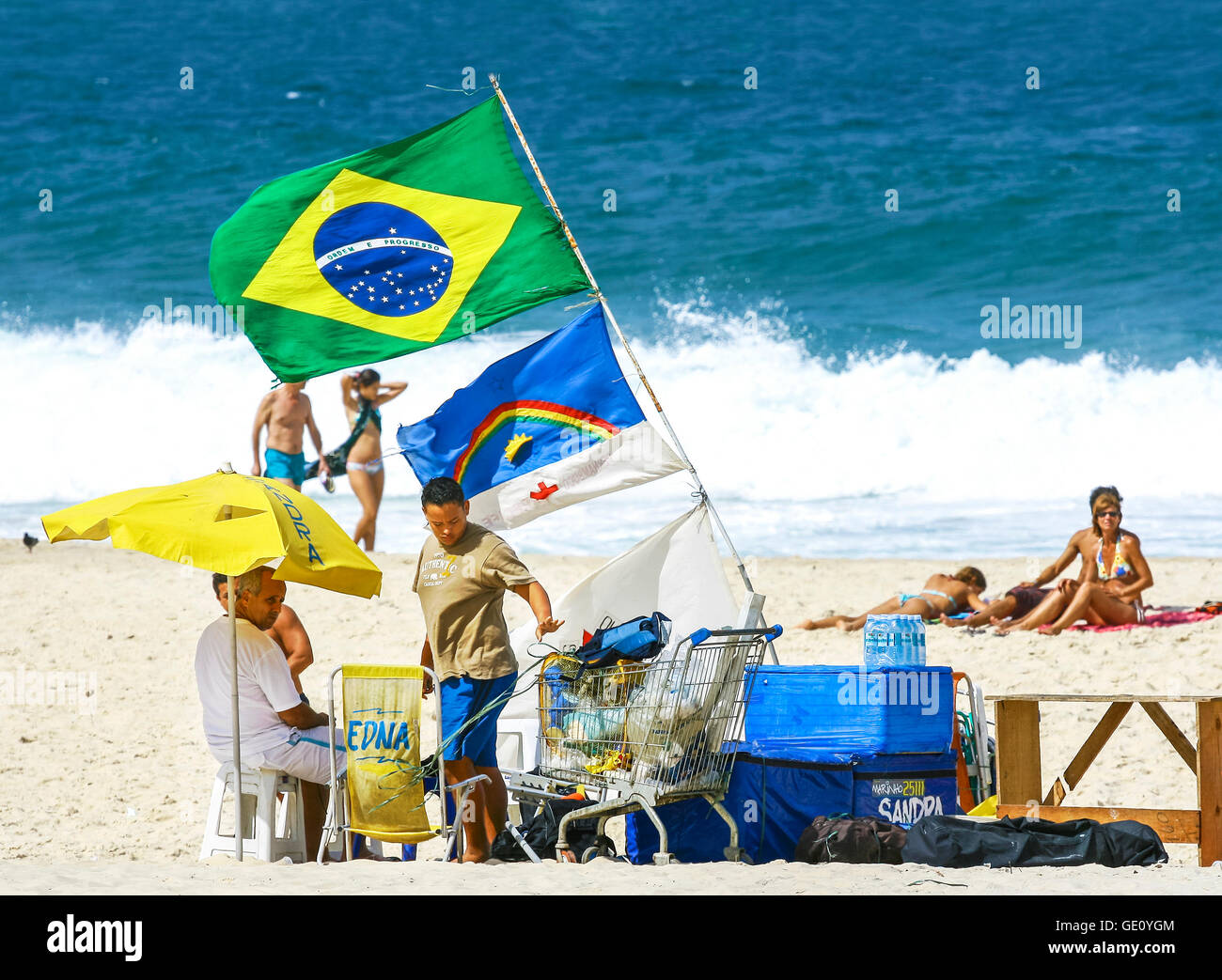 RIO DE JANEIRO, BRAZIL - AUGUST 27, 2008: Copacabana beach in summer day, vendors and sunbathers. Stock Photo