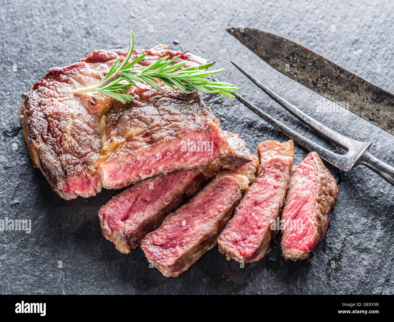 Medium Rib eye steak on the graphite tray. Stock Photo