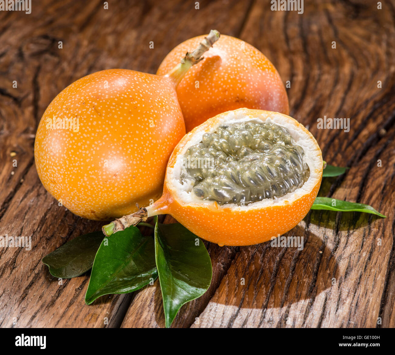 Granadilla fruits on the wooden table. Stock Photo