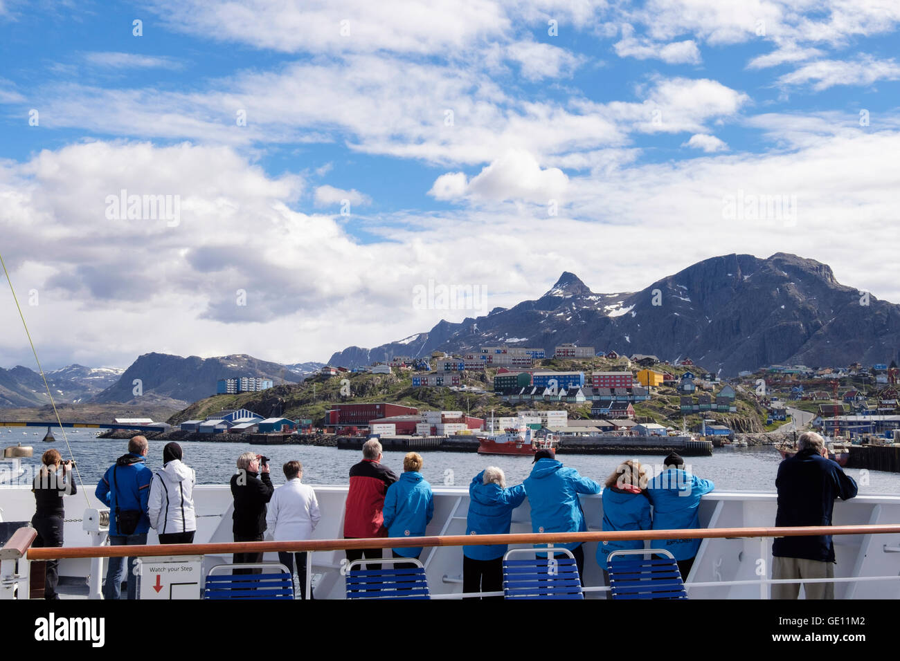 Passengers on outside deck on MV Fram cruise ship approaching port along Davis Strait. Sisimiut (Holsteinsborg) West Greenland Stock Photo