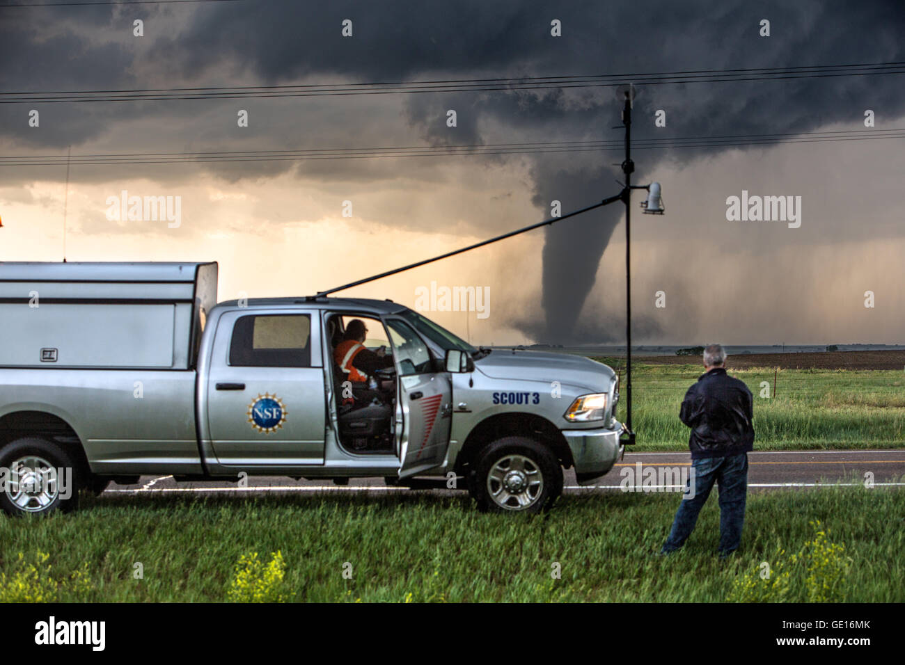 Storm chasers Tim Marshall and Brandon Molyneaux observe a tornado near Dodge City, Kansas, May 24, 2016. Stock Photo