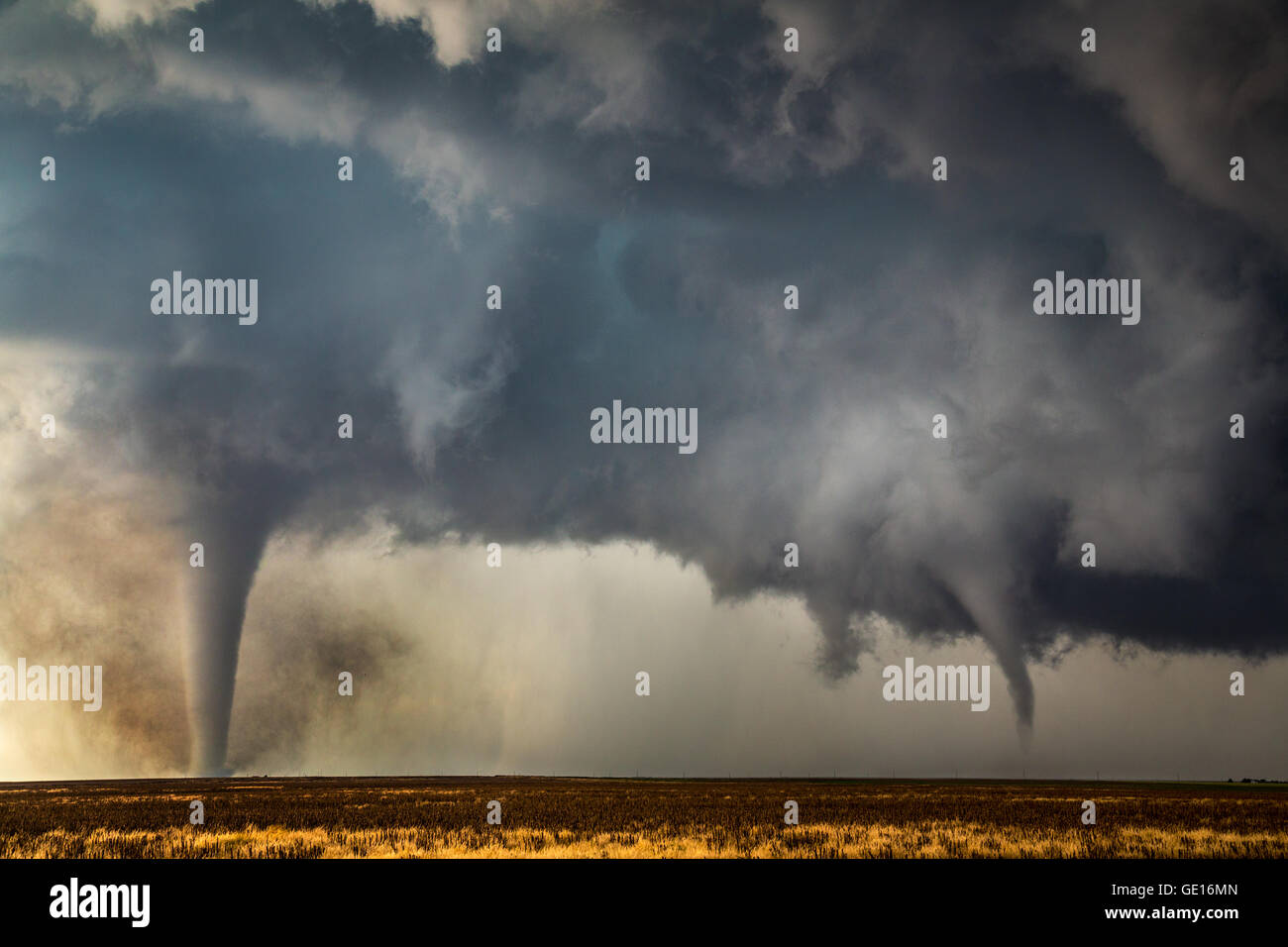 Two tornadoes descend from a supercell near Dodge City, Kansas, May 24, 2016.  These tornadoes were two of 15 tornadoes this storm produced. Stock Photo