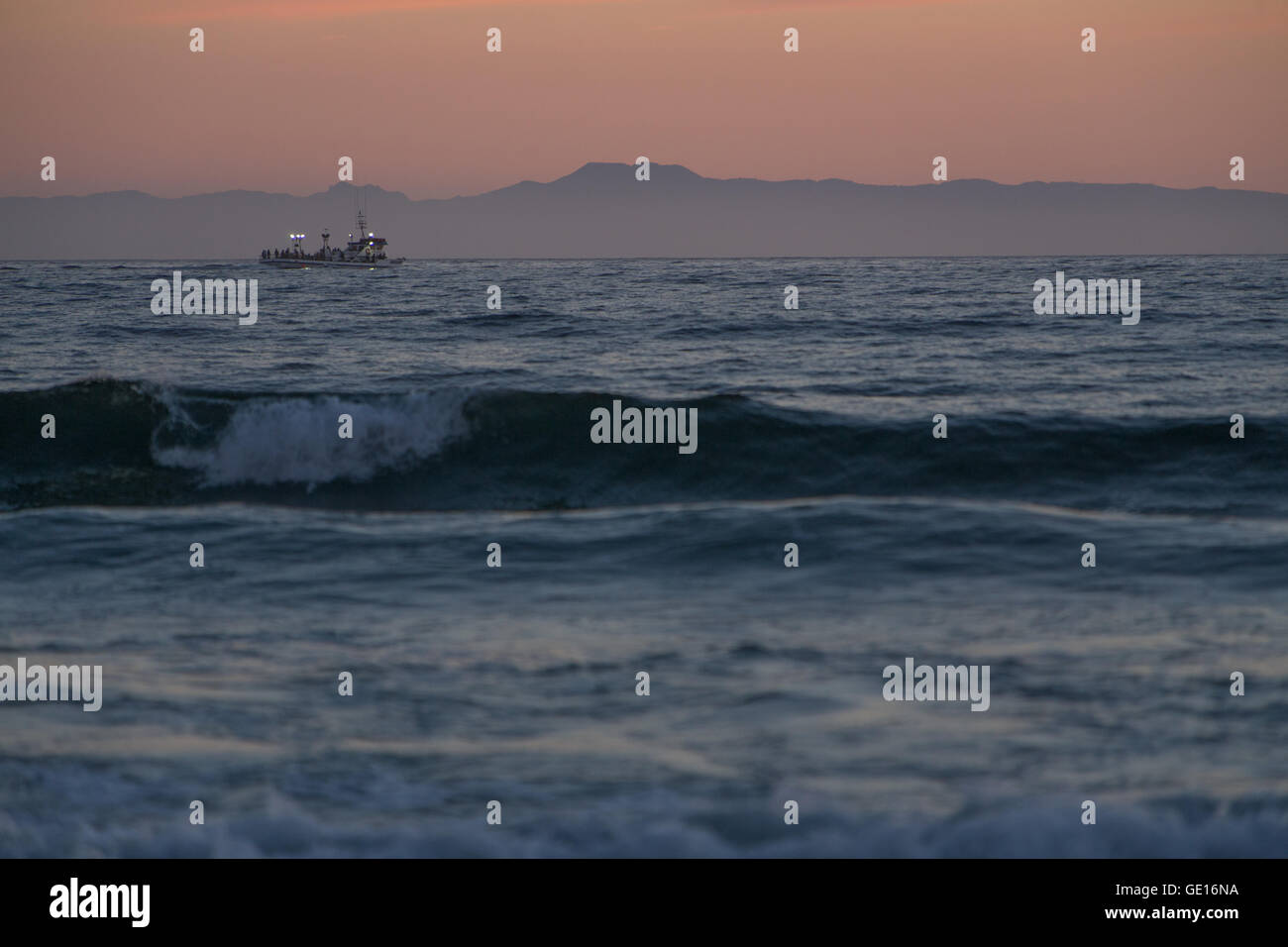 A boat in the distance at Newport Beach, Los Angeles, California. Stock Photo