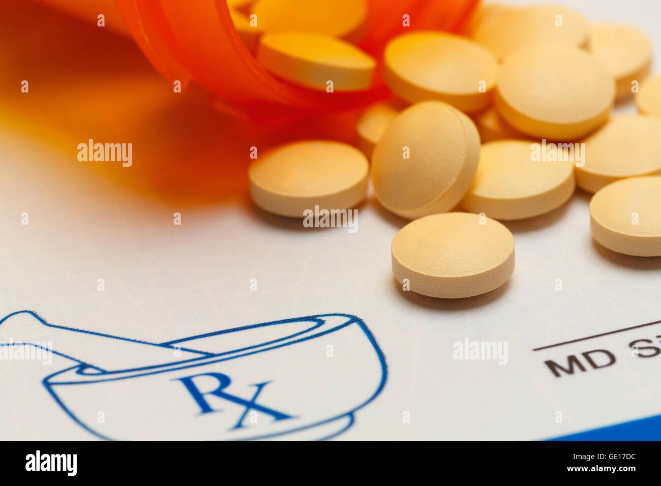 Orange Pills Spilled on RX Medicine Prescription Doctors Note. Stock Photo