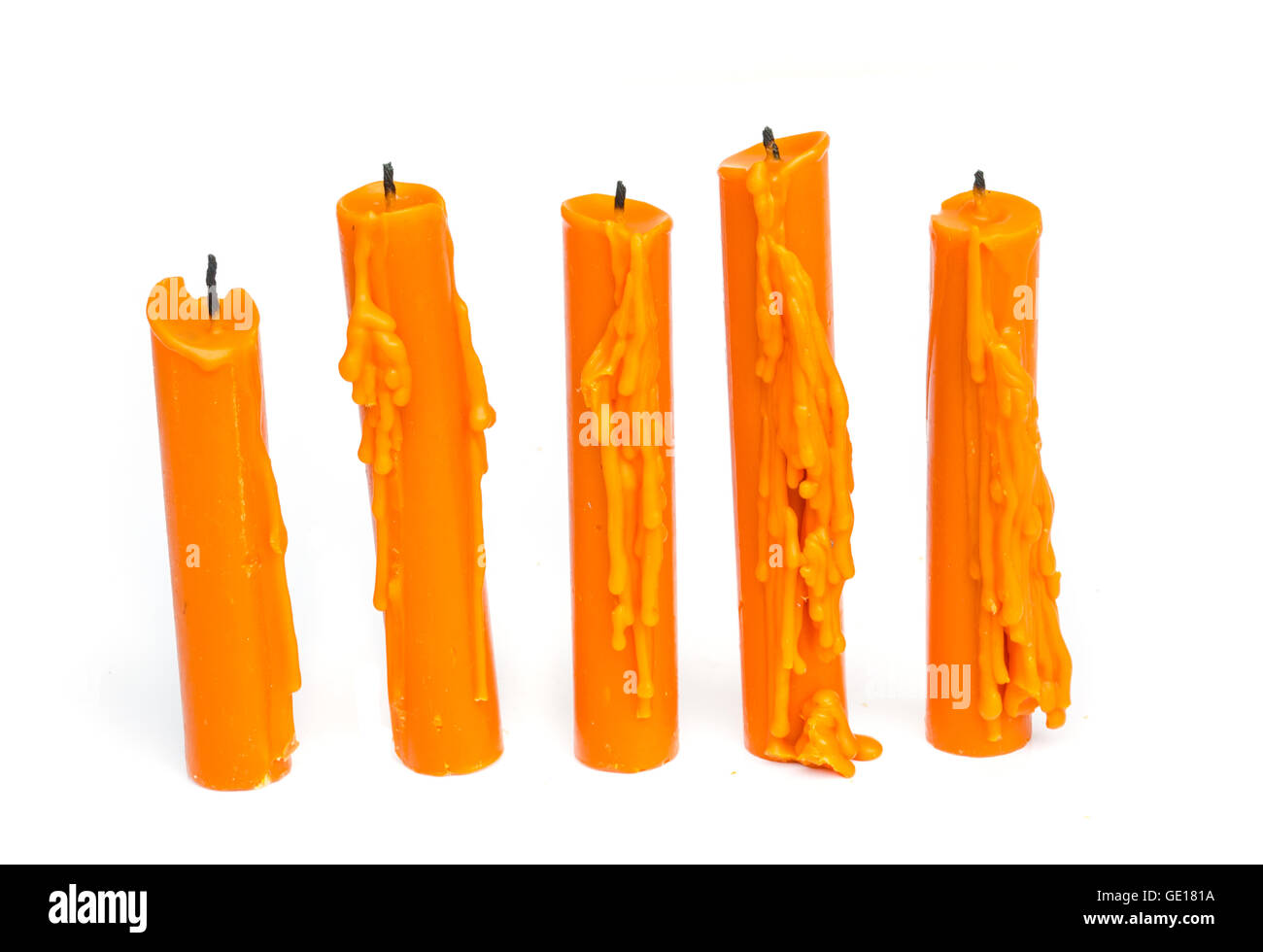 Yellow candle with candle drippings on white background Stock Photo Alamy